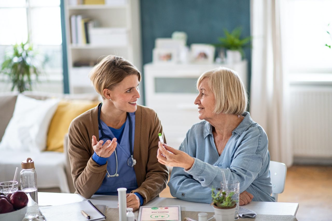 caregiver-or-healthcare-worker-with-senior-woman-patient-measuring-blood-glucose-indoors-.jpg