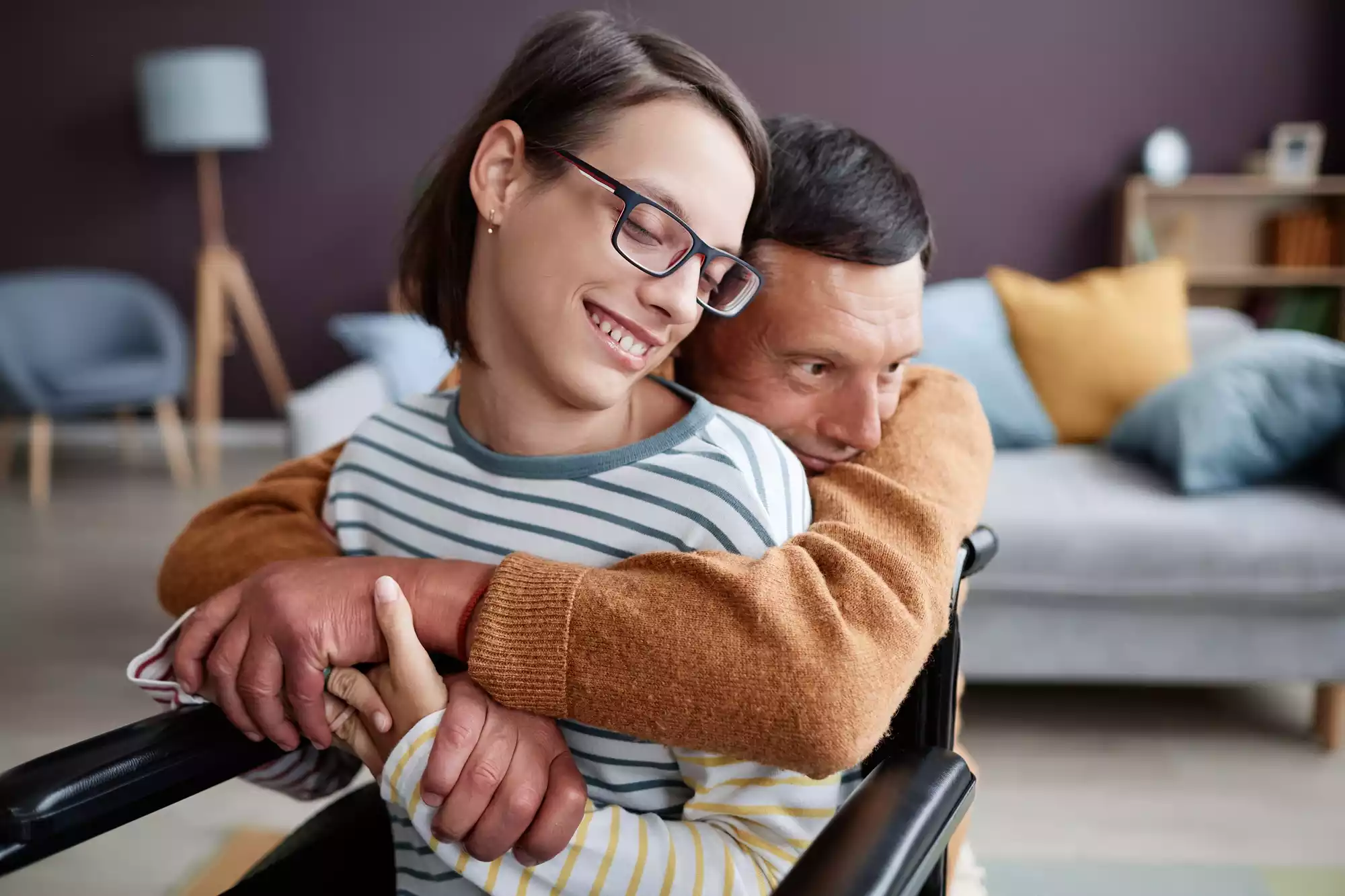 caring-father-embracing-smiling-girl-with-disabili-2025-03-09-18-24-15-utc