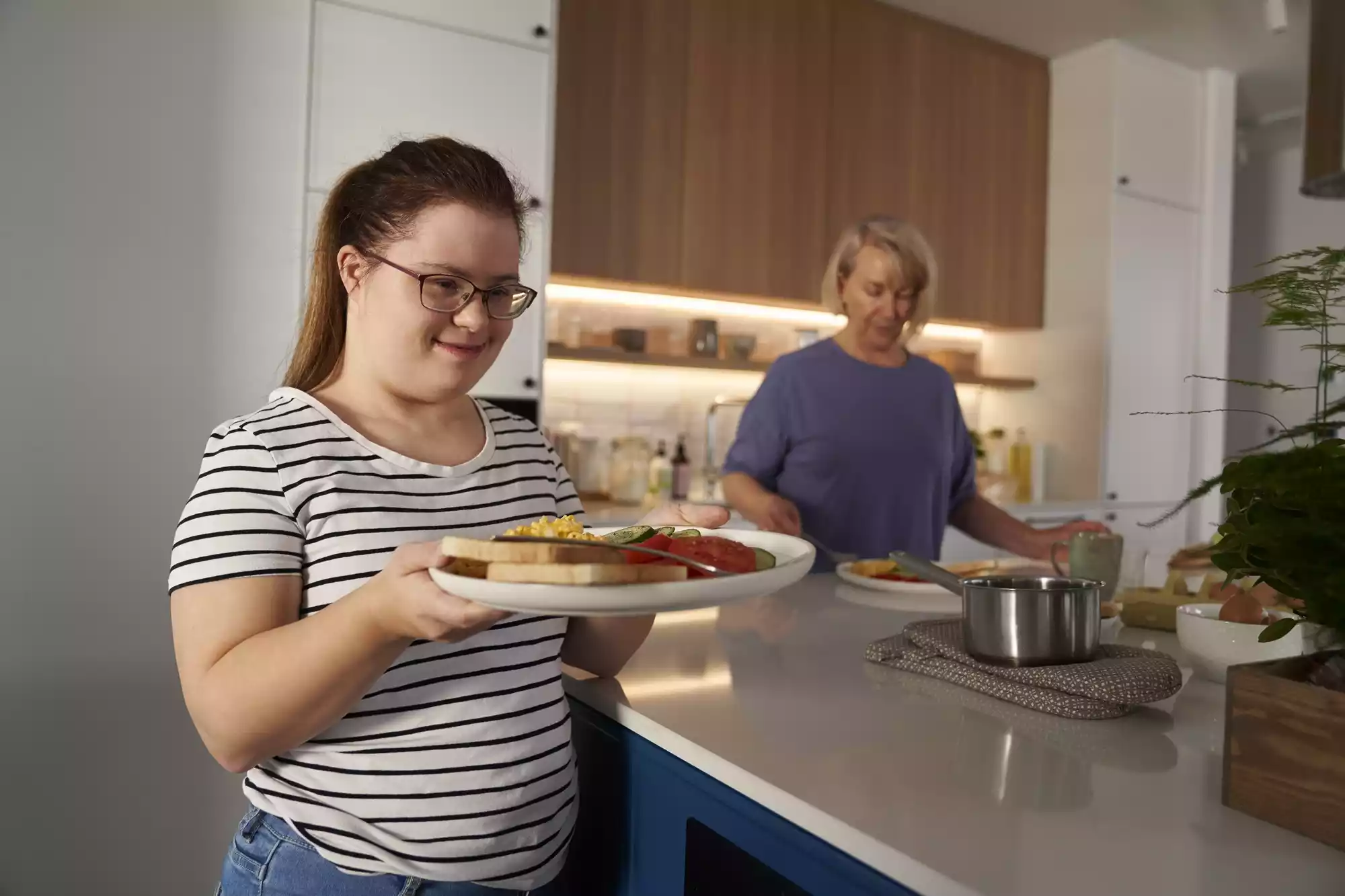 down-syndrome-woman-serving-breakfast-2024-12-05-09-45-27-utc