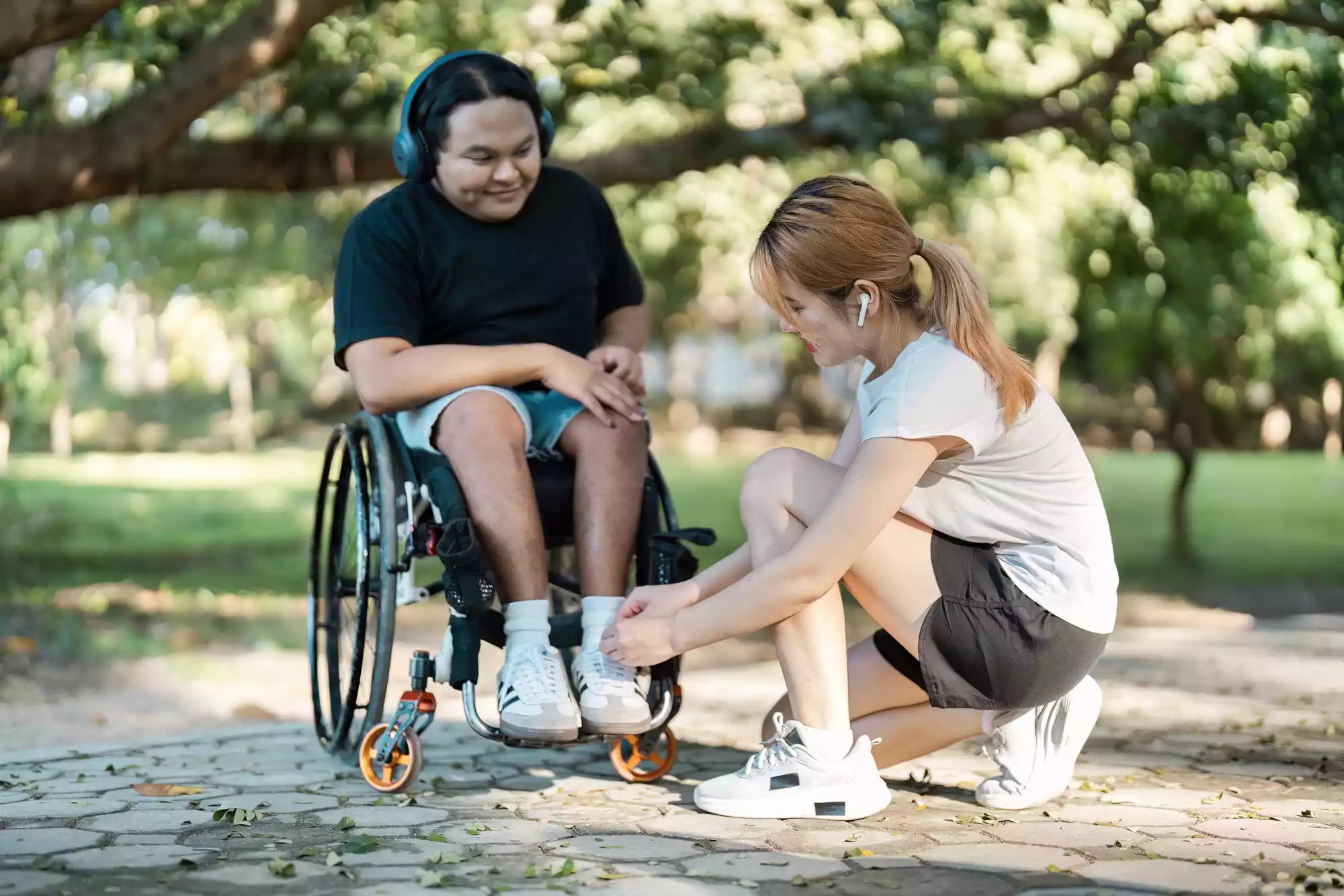 young-woman-assisting-man-in-wheelchair-outdoors-2025-02-20-02-22-32-utc