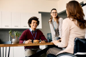 Group of colleagues enjoying in conversation during their lunch break at work.